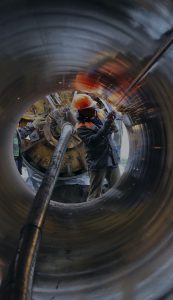 Workers working on a large pipeline