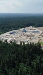 An aerial photo of an industrial area in the middle of a forest