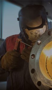 Man wearing protective equipment welding