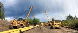 A picture of construction equipment and workers under a cloudy day