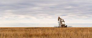 A lone oil rig in the middle of some grasslands