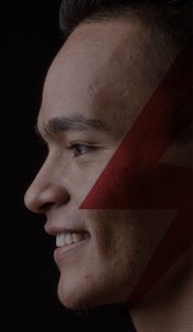 A man's face with a strike logo.